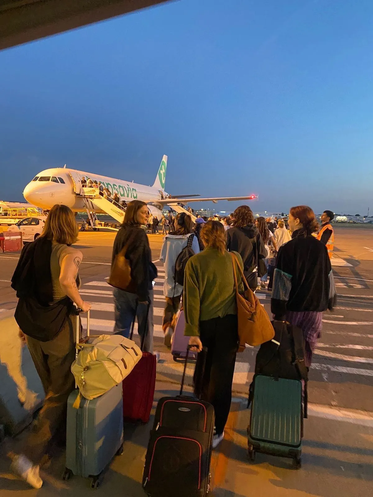 Guests boarding a flight at dusk