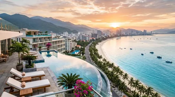 Infinity pool overlooking a coastal city at sunset