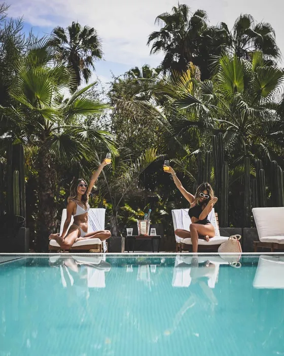 Guests relaxing by a tropical pool